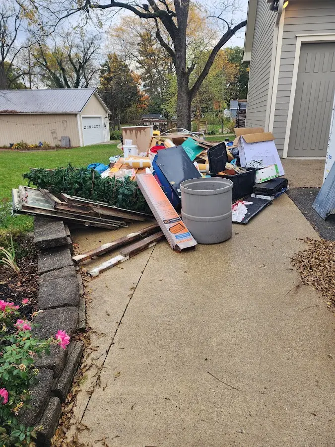 Dumpster being loaded with debris for Roofing Dumpster Rental in Red Bank